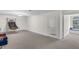 Carpeted basement featuring basketball rack, doors, and windows at 6709 Windchase Dr, Rocky Mount, NC 27803