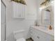 Well lit bathroom with white cabinets, sink, toilet, and mirror at 6709 Windchase Dr, Rocky Mount, NC 27803