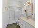 Well lit bathroom featuring a glass door shower, sink, toilet, and white cabinets at 6709 Windchase Dr, Rocky Mount, NC 27803