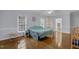 Primary bedroom with bright light, hardwood floors and access to primary bathroom at 6709 Windchase Dr, Rocky Mount, NC 27803