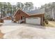 Brick home featuring attached garage and a detached garage with ample parking space at 6709 Windchase Dr, Rocky Mount, NC 27803