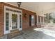 Cozy covered front porch with hanging swing, classic brick, and decorative details at 6709 Windchase Dr, Rocky Mount, NC 27803