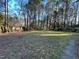 Spacious and private backyard with mature trees, grass, landscaping and stone border at 7780 Brookdale Dr, Raleigh, NC 27616