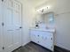 Bathroom featuring modern vanity, sink, mirror and neutral color palette at 7780 Brookdale Dr, Raleigh, NC 27616