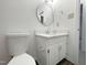 Bathroom featuring modern sink, vanity, and a round mirror at 7780 Brookdale Dr, Raleigh, NC 27616