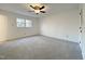 A simple and well lit bedroom with a ceiling fan and closet at 7780 Brookdale Dr, Raleigh, NC 27616