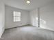 Bright bedroom with neutral color palette, carpet, and a window allowing for natural light at 7780 Brookdale Dr, Raleigh, NC 27616