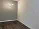 Dining area featuring a modern light fixture, gray wall, and wood-look flooring at 7780 Brookdale Dr, Raleigh, NC 27616
