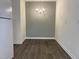Cozy dining area with modern chandelier, gray accent wall, and wood-look flooring at 7780 Brookdale Dr, Raleigh, NC 27616