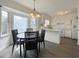 Dining area featuring large bright windows, pendant lights, and view of the kitchen at 7780 Brookdale Dr, Raleigh, NC 27616