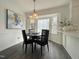 Bright dining area with large bay window, pendant lighting, and view of the kitchen at 7780 Brookdale Dr, Raleigh, NC 27616