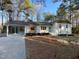 Attractive house exterior featuring brick, a carport, and a neatly maintained front yard at 7780 Brookdale Dr, Raleigh, NC 27616