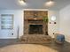 Close-up view of brick fireplace with wooden mantel and decorative accents at 7780 Brookdale Dr, Raleigh, NC 27616
