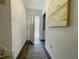 Bright hallway with hardwood floors, an open front door, and a decorative painting on the wall at 7780 Brookdale Dr, Raleigh, NC 27616