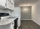 Bright kitchen with white cabinets, granite countertops, modern appliances and dining area at 7780 Brookdale Dr, Raleigh, NC 27616