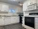 Well-lit kitchen featuring granite countertops, stainless sink, and modern appliances at 7780 Brookdale Dr, Raleigh, NC 27616