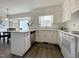 Bright kitchen with white cabinets, granite countertops, stainless steel dishwasher, and breakfast nook at 7780 Brookdale Dr, Raleigh, NC 27616