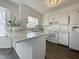 Bright kitchen with white cabinets, marble countertops, and modern appliances at 7780 Brookdale Dr, Raleigh, NC 27616