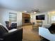 Spacious living room with fireplace, TV, ceiling fan, and comfortable seating at 7780 Brookdale Dr, Raleigh, NC 27616