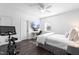 Bright bedroom with a comfortable bed, modern ceiling fan, mounted tv, and a Peloton bike for at-home workouts at 8401 Zinc Autumn Path Path, Raleigh, NC 27615