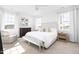 Sunlit primary bedroom featuring a comfortable bed, large windows, a ceiling fan, and modern furnishings at 8401 Zinc Autumn Path Path, Raleigh, NC 27615