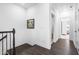 Well-lit hallway features beautiful dark floors at 8401 Zinc Autumn Path Path, Raleigh, NC 27615