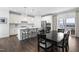 Eat-in kitchen featuring white cabinets, stainless steel appliances, and a dining area with access to the outdoors at 8401 Zinc Autumn Path Path, Raleigh, NC 27615