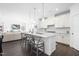 Open-concept kitchen with a large island, white cabinets, and seamless flow into the living area at 8401 Zinc Autumn Path Path, Raleigh, NC 27615