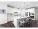 Bright kitchen with white cabinetry, sleek countertops, and a spacious island with stylish seating at 8401 Zinc Autumn Path Path, Raleigh, NC 27615