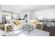 Stylish open-concept living room with a plush sofa, glass coffee table, and contemporary design elements at 8401 Zinc Autumn Path Path, Raleigh, NC 27615