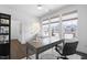 Well-lit office features hardwood floors, large windows offering neighborhood views, desk, chair, and ample space at 8401 Zinc Autumn Path Path, Raleigh, NC 27615