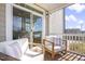 Cozy outdoor patio boasts comfortable seating with white cushions and wooden frames, perfect for relaxing at 8401 Zinc Autumn Path Path, Raleigh, NC 27615