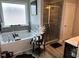 Modern bathroom with a soaking tub, tiled shower, and coordinated black accessories at 94 Aylebury Rdg, Zebulon, NC 27597