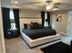 Spacious bedroom featuring a decorative tray ceiling, soft carpet, and contemporary furnishings at 94 Aylebury Rdg, Zebulon, NC 27597