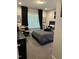 Cozy bedroom features a large window, drum set, and comfortable-looking gray bedding at 94 Aylebury Rdg, Zebulon, NC 27597