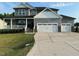 Beautiful two-story home with a three car garage, and welcoming front porch with gray vinyl siding at 94 Aylebury Rdg, Zebulon, NC 27597