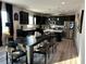 Stylish kitchen with black cabinetry, stainless steel appliances, and an island with bar seating at 94 Aylebury Rdg, Zebulon, NC 27597