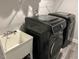 Neat laundry room with modern machines and sink basin for washing at 94 Aylebury Rdg, Zebulon, NC 27597