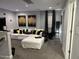 Inviting living room with an ample white sofa and soft grey carpet at 94 Aylebury Rdg, Zebulon, NC 27597