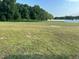 Open grassy lot with some surrounding trees at 94 Aylebury Rdg, Zebulon, NC 27597