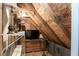 Unfinished attic space with exposed wood and a dark television on a shelf at 10115 Mizner Ln, Raleigh, NC 27617