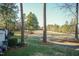 Backyard view showcasing lush greenery and a golf course, providing a serene atmosphere at 10115 Mizner Ln, Raleigh, NC 27617