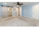Cozy bedroom featuring a sliding barn door, plush carpeting, ceiling fan, and ample closet space at 10115 Mizner Ln, Raleigh, NC 27617