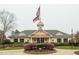 A charming community center with an American flag and manicured grounds at 10115 Mizner Ln, Raleigh, NC 27617
