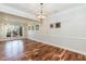Spacious dining room featuring hardwood floors, large windows, decorative crown molding and light fixture at 10115 Mizner Ln, Raleigh, NC 27617