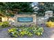 Well-maintained entrance sign for the Village of Talamore with colorful floral arrangements at 10115 Mizner Ln, Raleigh, NC 27617