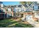 Charming two-story home with manicured front yard and cozy front porch that has decorative plants and seating at 10115 Mizner Ln, Raleigh, NC 27617