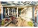 Cozy front porch featuring decorative flower baskets, an entrance wreath, and comfortable seating with landscaping at 10115 Mizner Ln, Raleigh, NC 27617