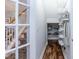 Well-organized hallway with built-in shelves, hardwood floors, and visible staircase at 10115 Mizner Ln, Raleigh, NC 27617