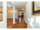 Hallway with gleaming hardwood floors and an open concept that leads into the dining room and Gathering room at 10115 Mizner Ln, Raleigh, NC 27617